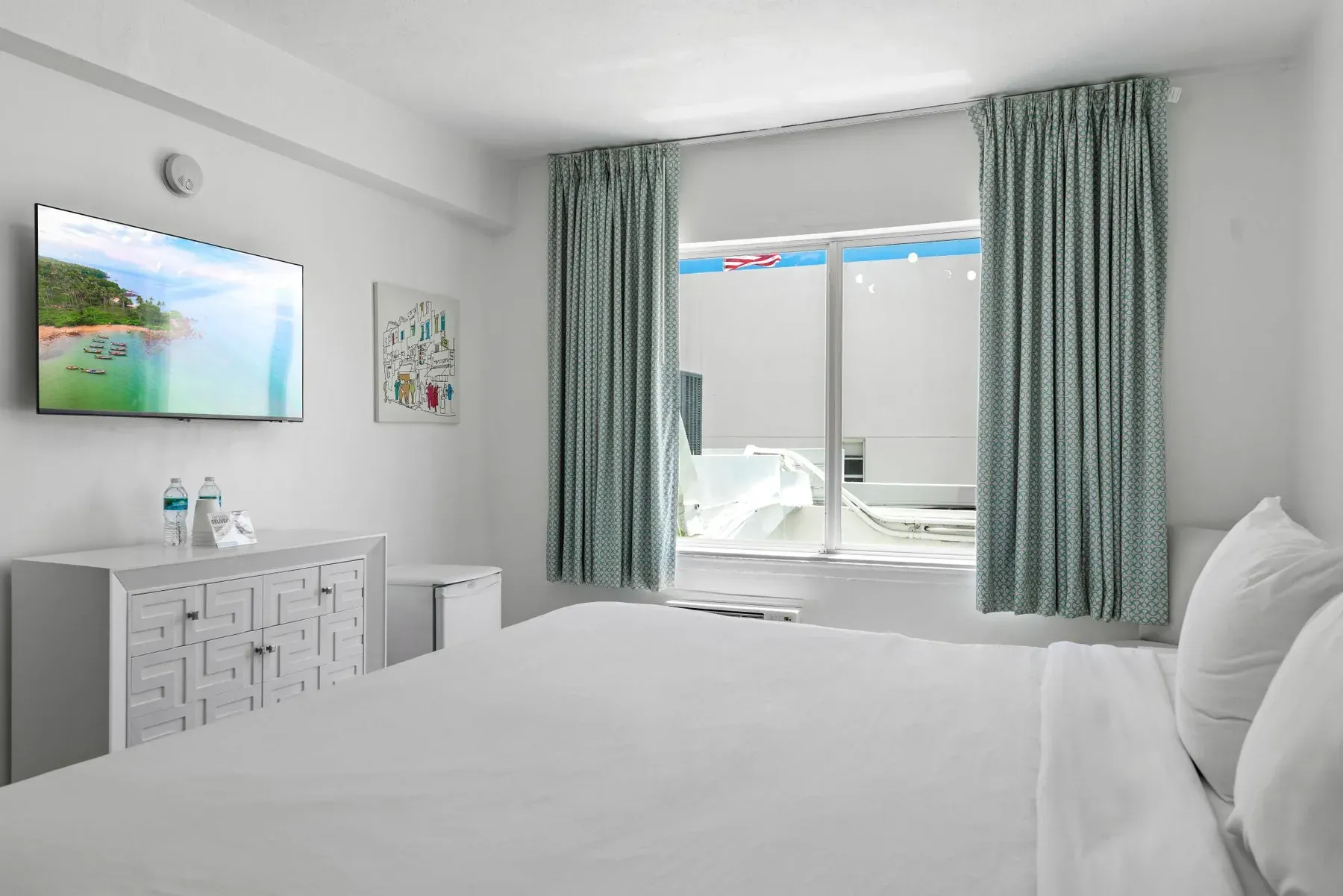 The bed with daylight through the teal curtains