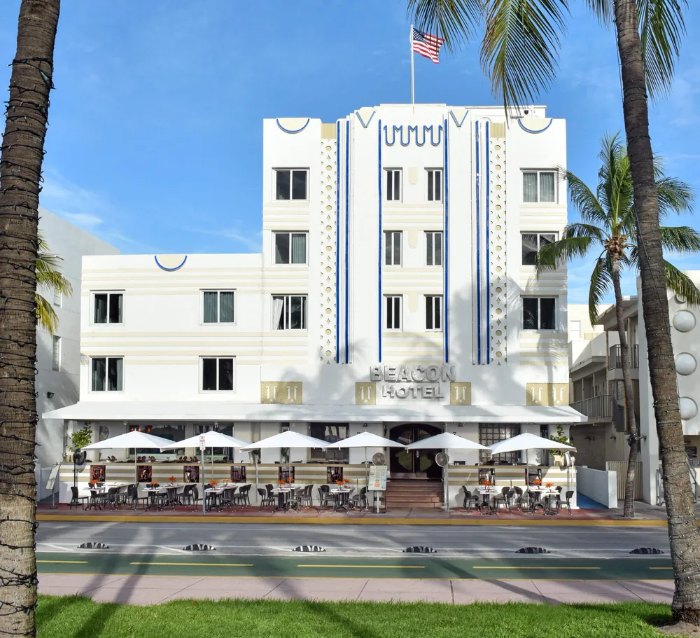The Beacon’s restored white Art Deco facade on Ocean Drive today, with the café terrace under the awning