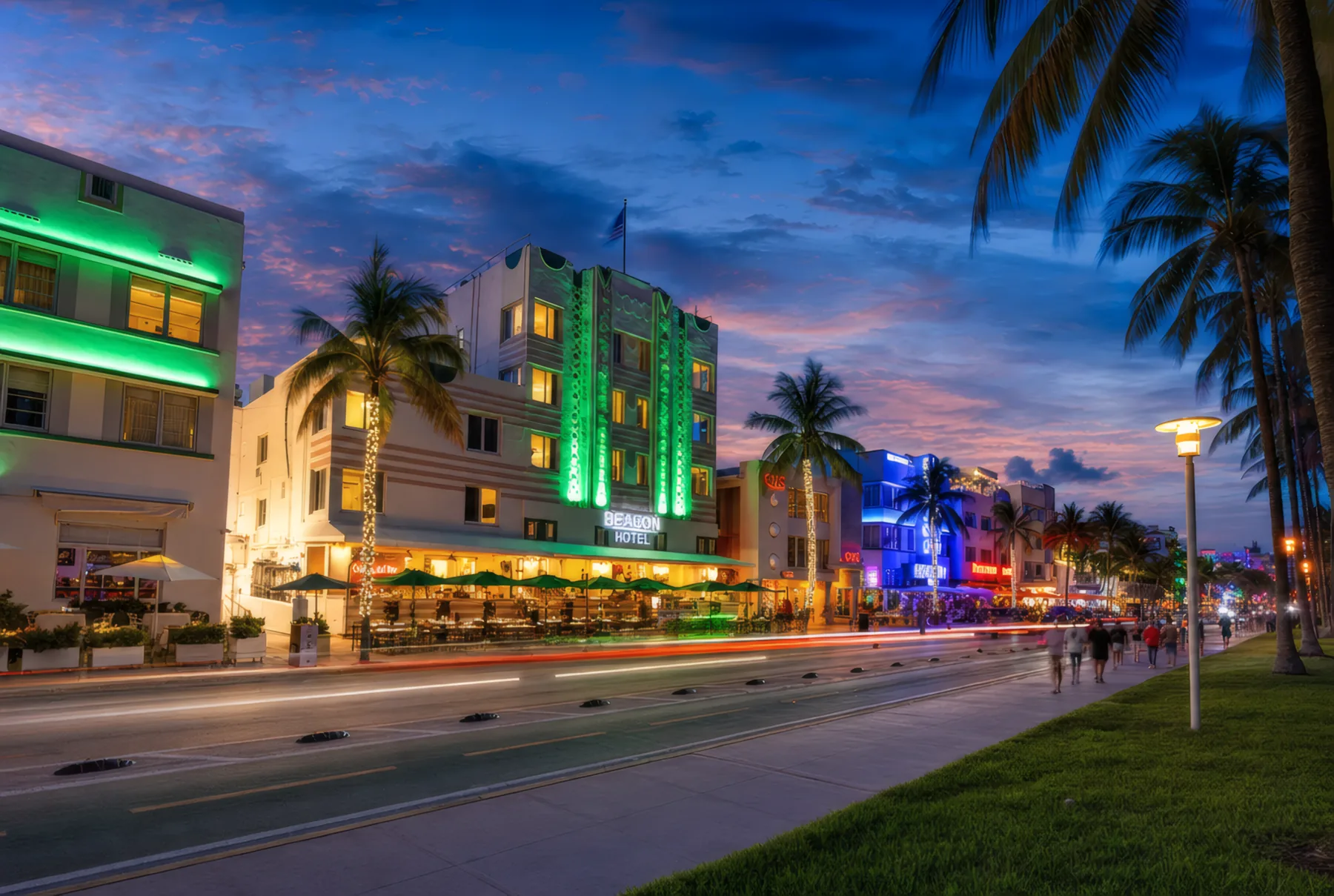 Ocean Drive at dusk, the Beacon’s green neon among the lit facades