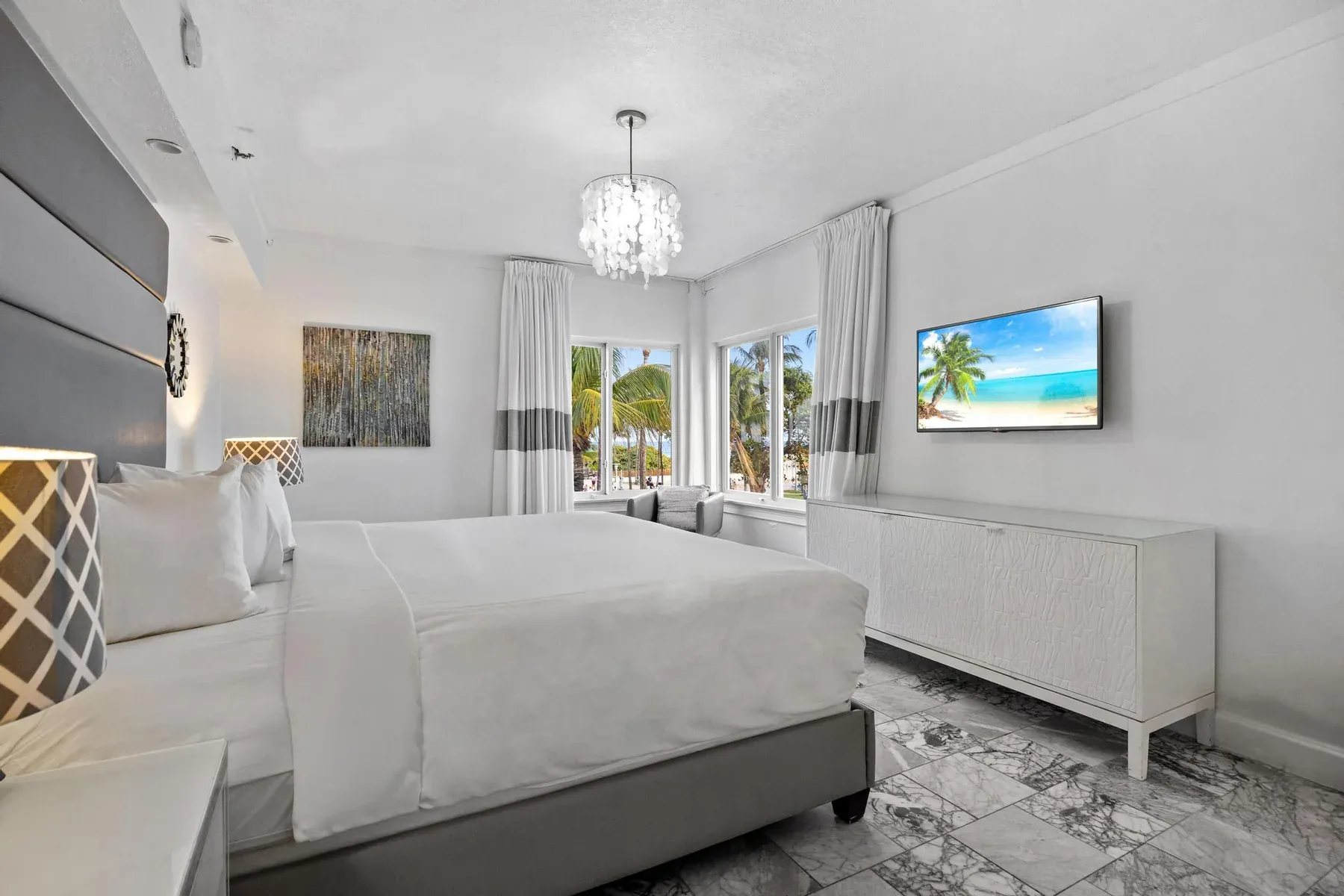 The suite bedroom with the television and dresser opposite the bed